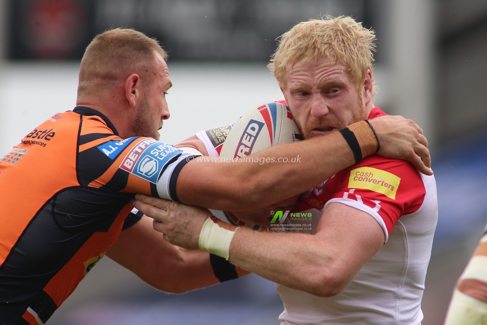 James Graham (32) of St Helens tackled by  Liam Watts (8) (Left) and Adam Milner (13) (Right) of Castleford Tigers.