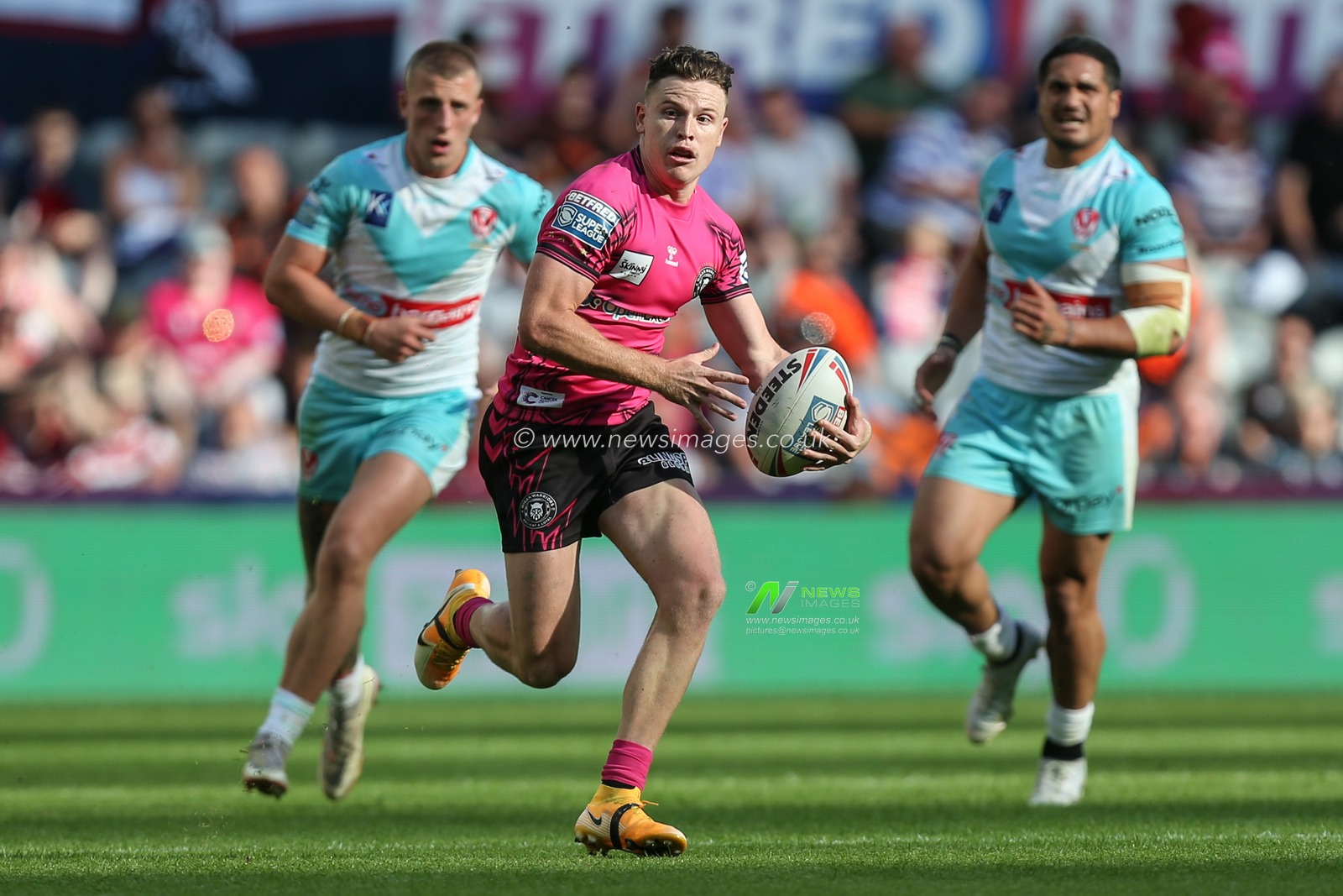 Jai Field #23 of Wigan Warriors runs with the ball