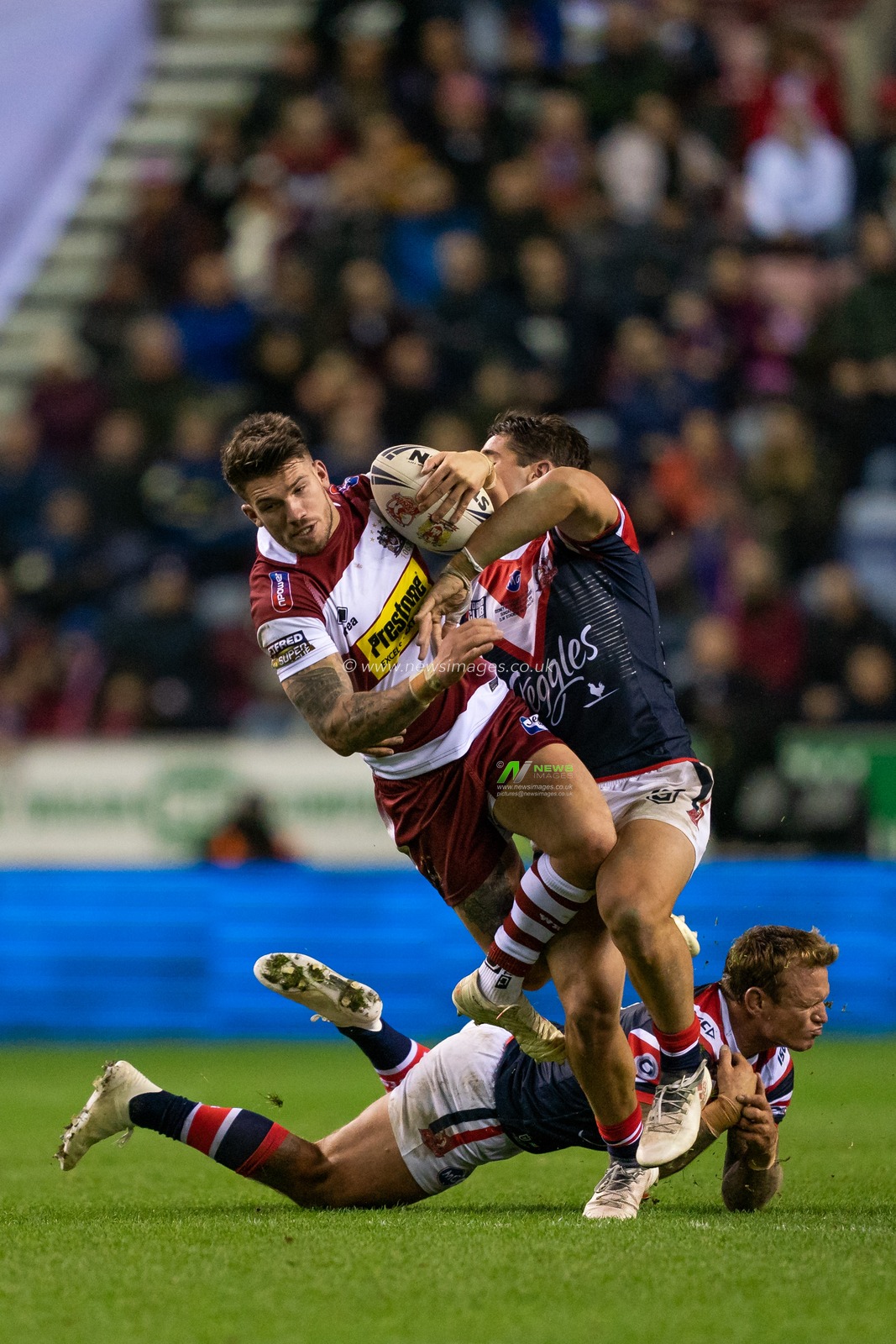 Wigan Warriors's Oliver Gildart is tackled by Sydney Roosters Nat Butcher


17th February  2019 , DW Stadium, Wigan, England;  Betfred World Club Challenge, Wigan Warriors vs Sydney Roosters ; 

Credit: Terry Donnelly/News Images