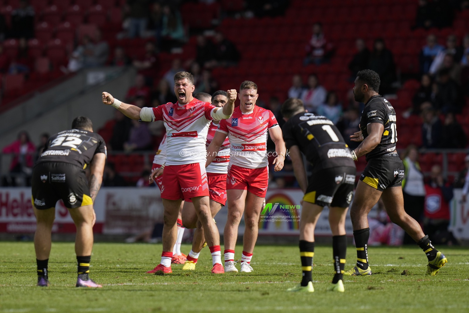 Louie McCarthy-Scarsbrook #15 of St Helens  leads the Saints players in celebrating reaching their 4th Grand Final in a row after the Betfred Super League match St Helens vs Salford Red Devils at Totally Wicked Stadium, St Helens, United Kingdom, 17th September 2022

(Photo by Steve Flynn/News Images)