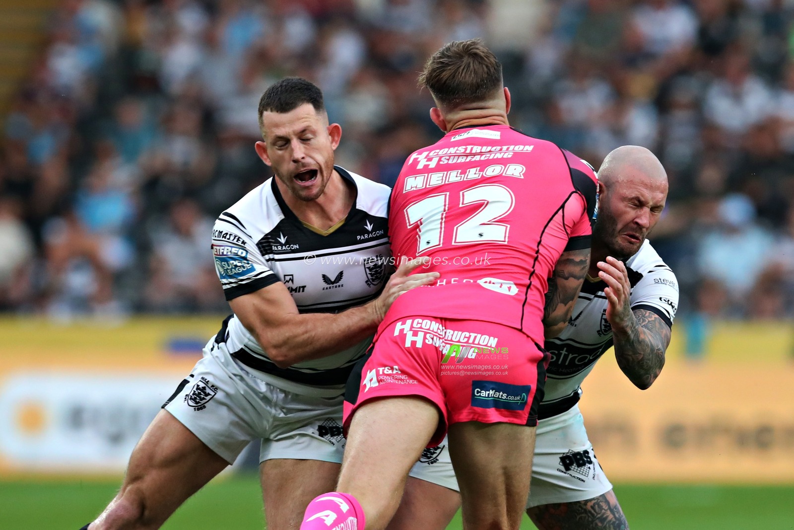 Cade Cust of Hull F.C. and Zak Hardaker of Hull F.C. tackle Alex Mellor of Castleford Tigers during the Betfred Super League Round 14 Hull FC vs Castleford Tigers at MKM Stadium, Hull, United Kingdom, 13th June 2025(Photo by Sam Eaden/News Images)