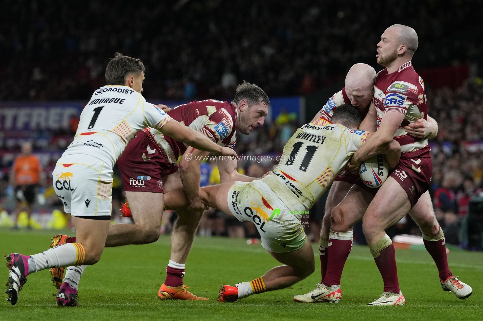 Liam Marshall #5 of Wigan Warriors   and Liam Farrell #12 of Wigan Warriors drag Matt Whitley #11 of Catalans Dragons towards touch during the Betfred Super League Grand Final match Wigan Warriors vs Catalans Dragons at Old Trafford, Manchester, United Kingdom, 14th October 2023

(Photo by Steve Flynn/News Images)
