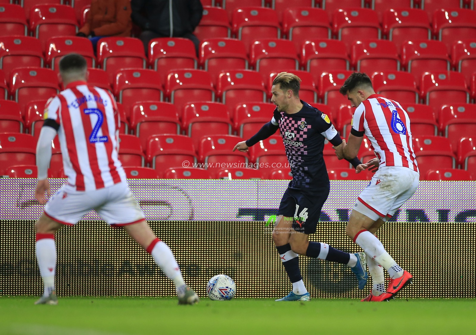 10th December 2019, Bet365 Stadium, Stoke-on-Trent, England; Sky Bet Championship, Stoke City v Luton Town : Harry Cornick (14) of Luton Town holds off Danny Baath (6) of Stoke City 

Credit: Conor Molloy/News Images