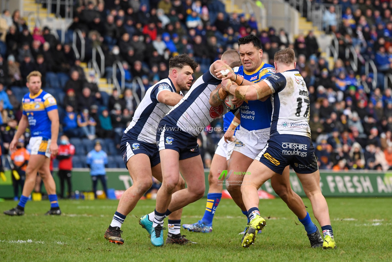 Zane Tetevano #13 of Leeds Rhinos starts an attacking move