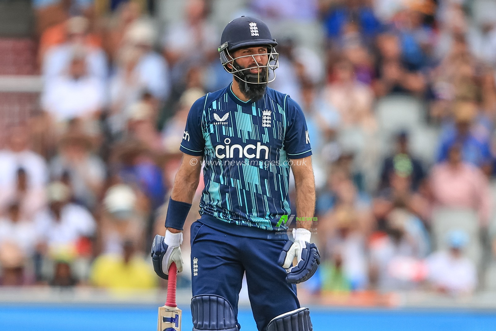 Moeen Ali of England looks at the scoreboard as he hits a six and also 2000 career ODI runs