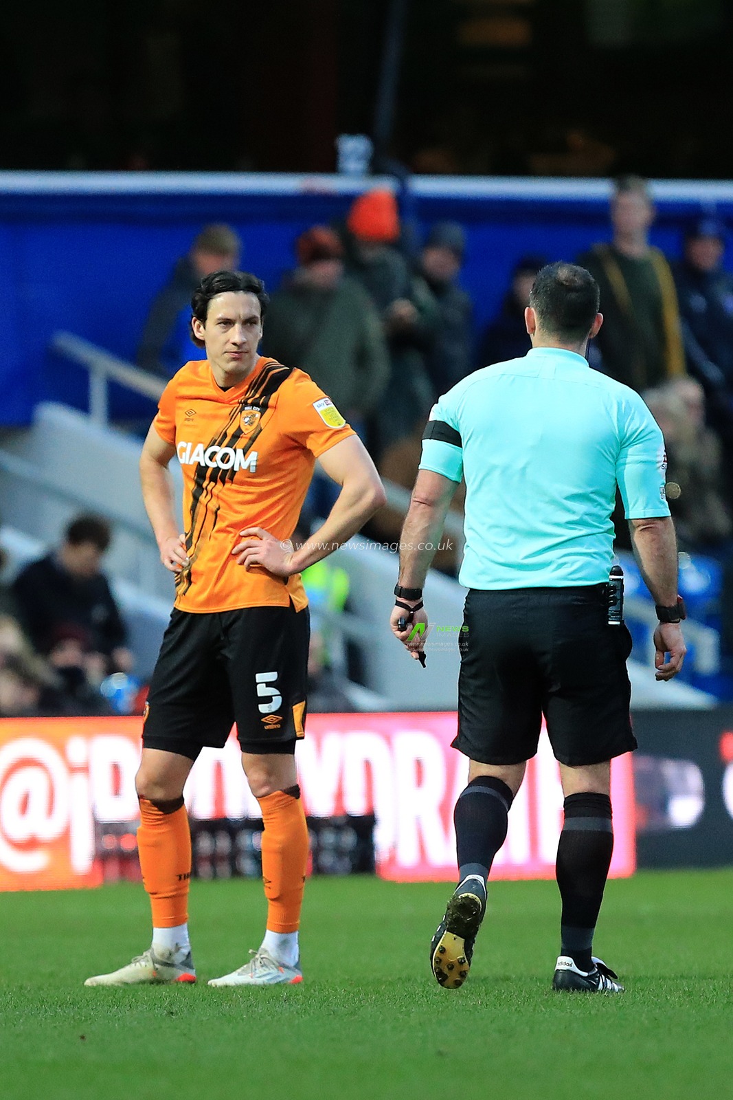 Alfie Jones #5 of Hull City speaking with referee, Tim Robinson.