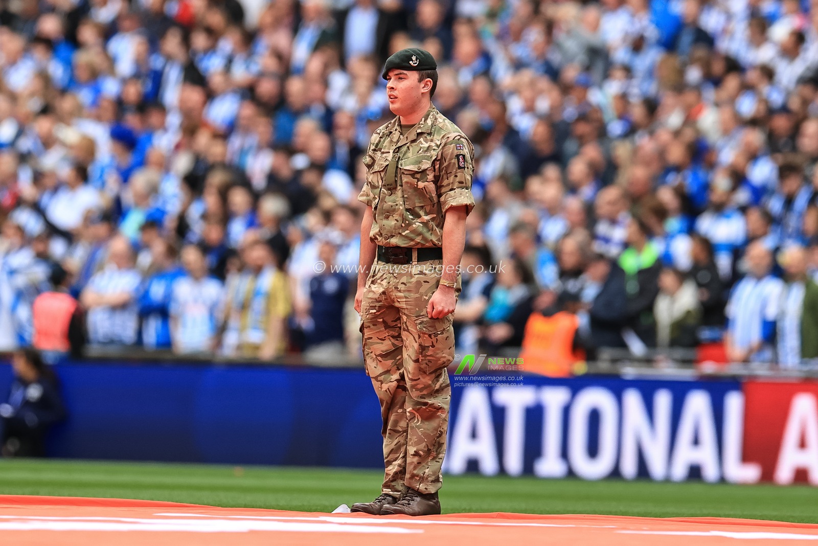 A British Army personnel sings â€˜God save our Queenâ€™
