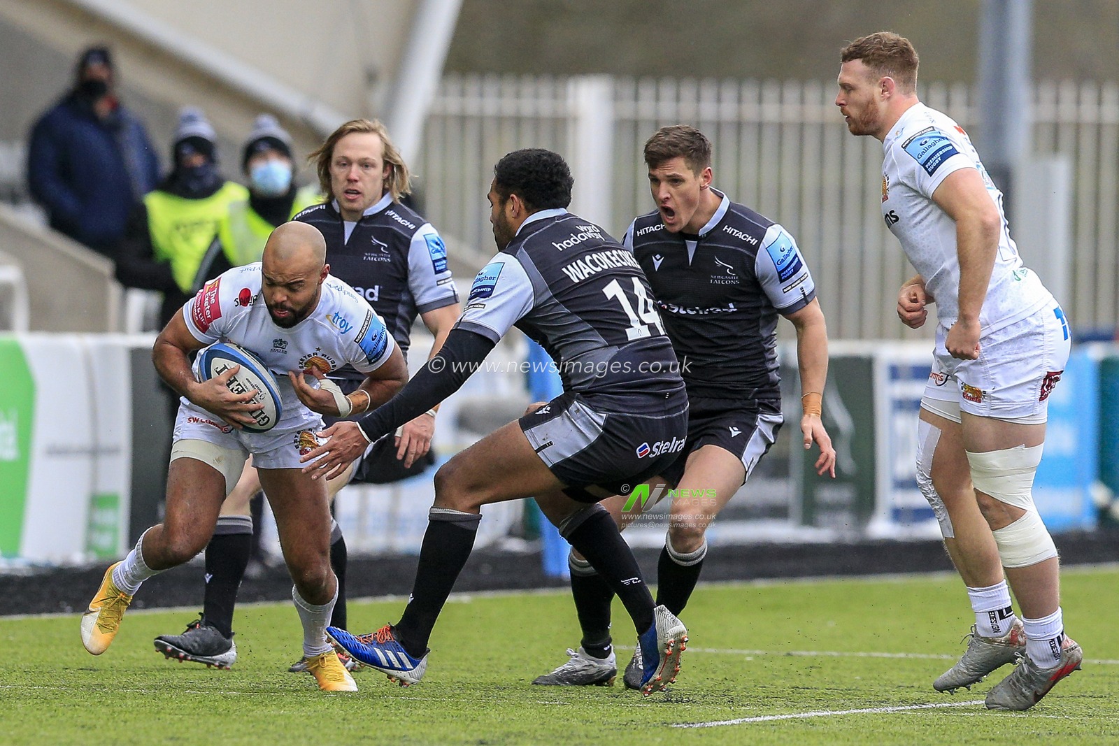 Tom O'Flaherty of Exeter Chiefs takes on George Wacokecoke of Newcastle Falcons