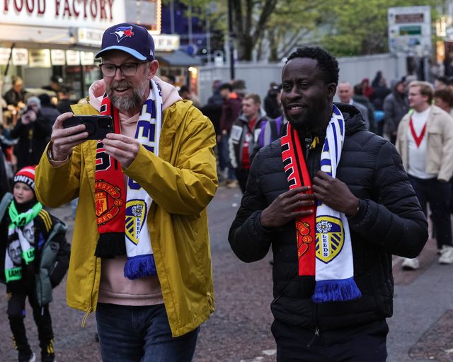 Fans make their way to the game wearing Manchester United v Leeds United scarfs during the Premier League match Manchester United vs Leeds United at Old Trafford, Manchester, United Kingdom on 13 April 2026

(Photo by Mark Cosgrove/News Images)