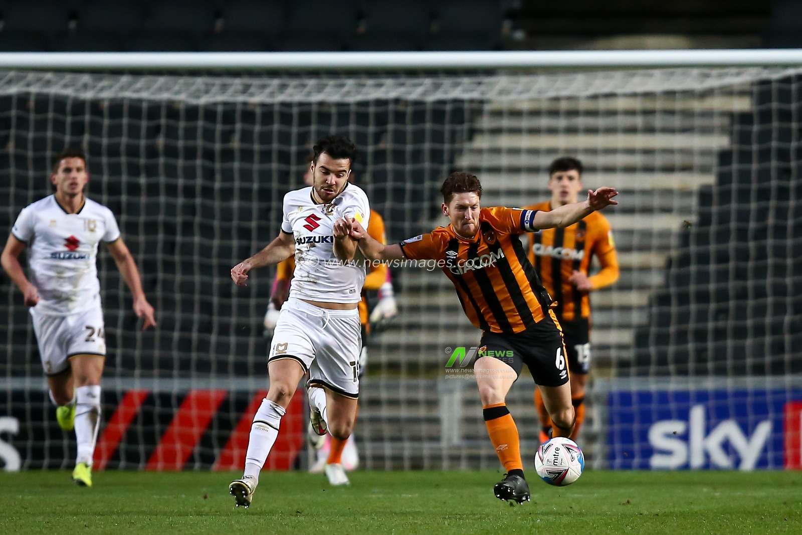 Richard Smallwood #6 of Hull City and Scott Fraser #10 of Milton Keynes Dons compete for the ball