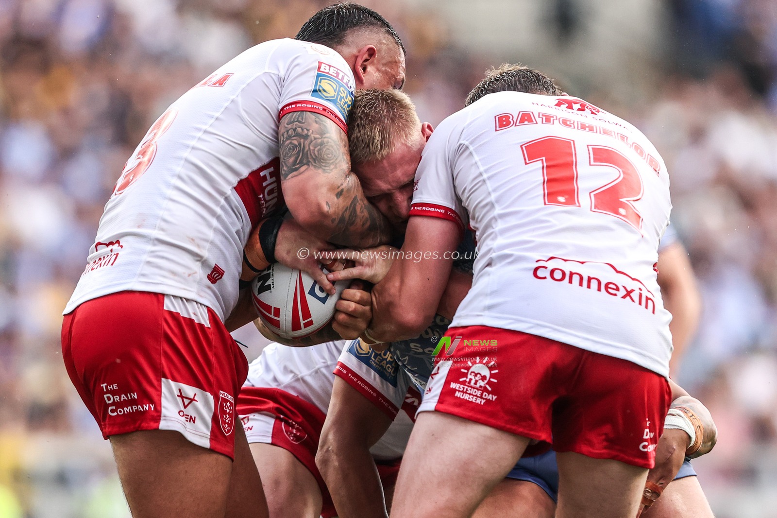 Mikołaj Olędzki of Leeds Rhinos is tackled by Elliot Minchella of Hull KR and James Batchelor of Hull KR during the Betfred Super League round 16 match Leeds Rhinos vs Hull KR at AMT Headingley Stadium, Leeds, United Kingdom on 26 June 2026

(Photo by Alfie Cosgrove/News Images)