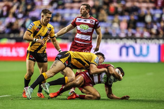 ﻿Kruise Leeming of Wigan Warriors is tackled by Sam Wood of Castleford Tigers and Brad Singleton of Castleford Tigers during the Betfred Super League Round 26 match Wigan Warriors vs Castleford Tigers at The Brick Community Stadium, Wigan, United Kingdom, 12th September 2025

(Photo by Alfie Cosgrove/News Images)