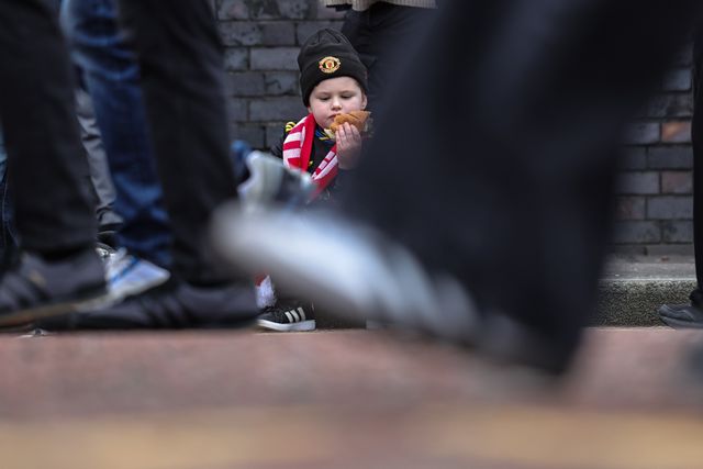 A young Manchester United fans sits in the road curb as he grabs a bite to eat during the Premier League match Manchester United vs Crystal Palace at Old Trafford, Manchester, United Kingdom on 01 March 2026

(Photo by Mark Cosgrove/News Images)