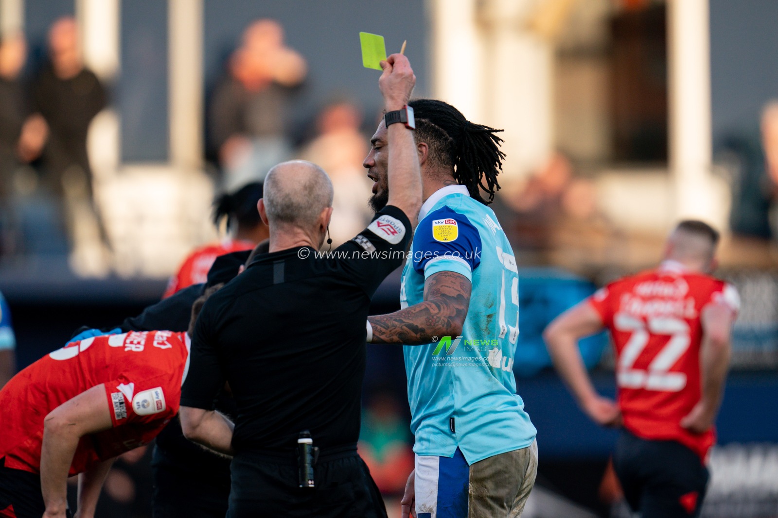 Colin Kazim-Richards #13 of Derby County receives a yellow card from referee Andy Woolmer