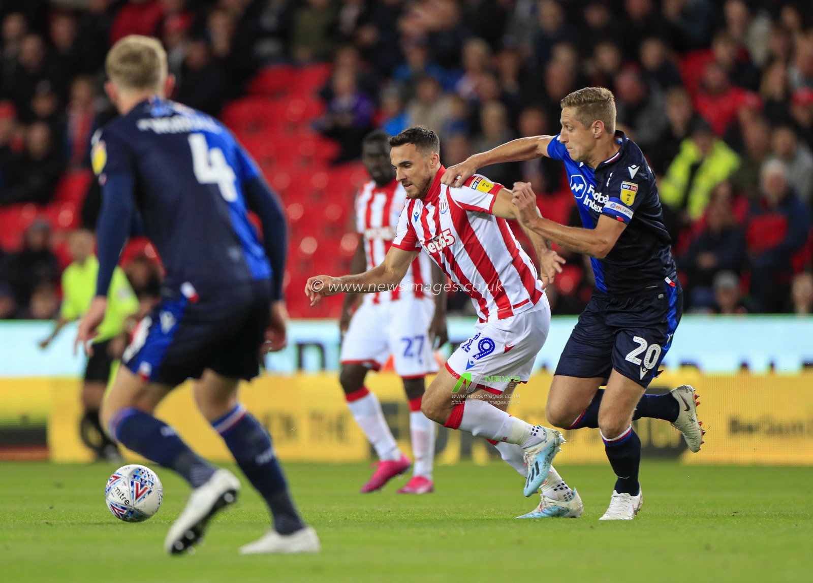 27th September 2019, Bet365 Stadium, Stoke-on-Trent, England; Sky Bet Championship, Stoke City v Nottingham Forest : Lee Gregory (19) of Stoke City is challenged by Michael Dawson (20) of Nottingham Forest

Credit: Conor Molloy/News Images