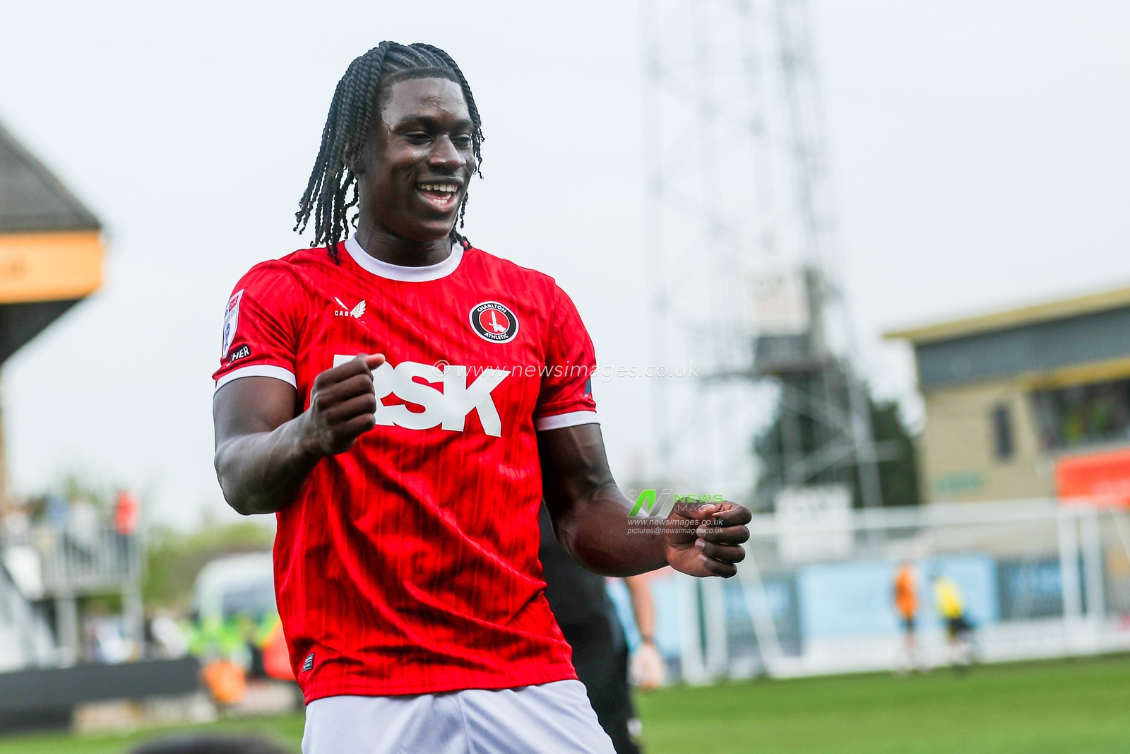 Micah Mbick of Charlton Athletic celebrates with the fans after the teams victory following the Sky Bet League 1 match Cambridge United vs Charlton Athletic at Cledara Abbey Stadium, Cambridge, United Kingdom, 12th April 2025

(Photo by Izzy Poles/News Images)