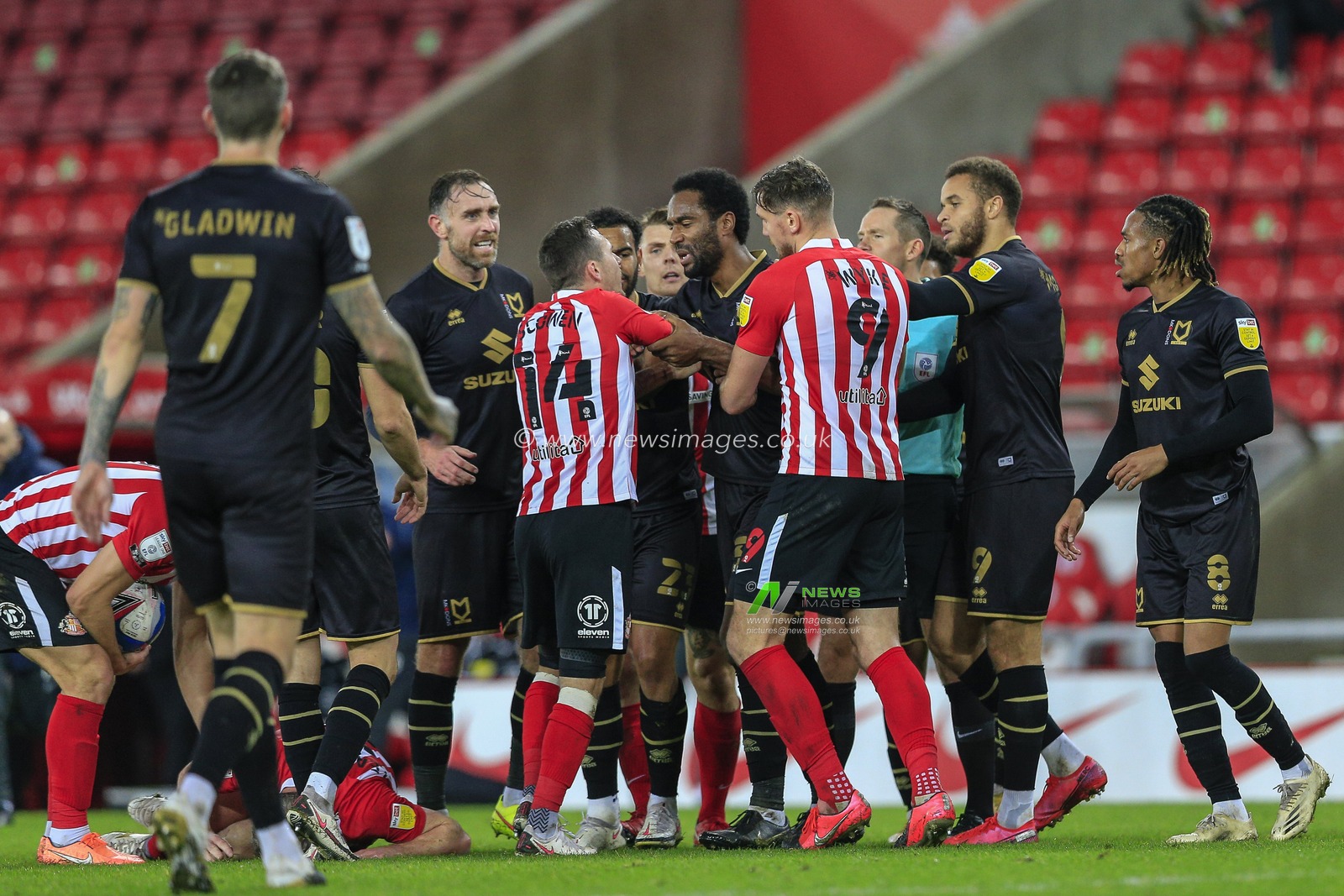 Cameron Jerome #35 of Milton Keynes Dons and Josh Scowen #14 of Sunderland discuss the foul by Carlton Morris #9 of Milton Keynes Dons on Grant Leadbitter #23 of Sunderland