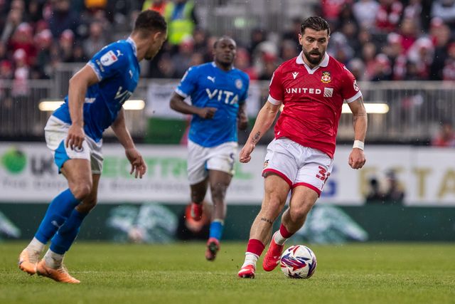Wrexham's Elliot Lee carries the ball during the Sky Bet League 1 match Wrexham vs Stockport County at SToK Cae Ras, Wrexham, United Kingdom, 22nd March 2025

(Photo by Nik Mesney/News Images)