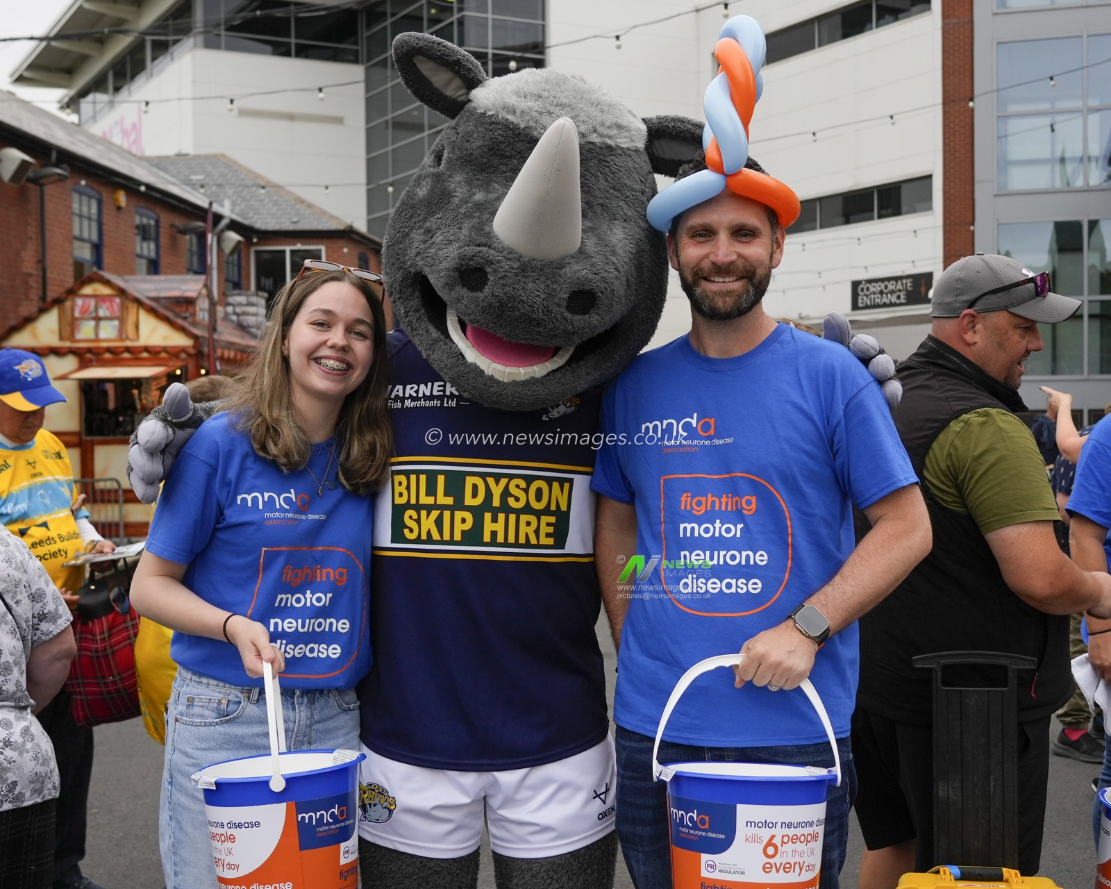 Volunteers with collection buckets for MND pose for a photo with Mascot, Ronnie the Rhino before the Motor Neurone Disease Awareness Game, the Betfred Super League Round 16 match Leeds Rhinos vs Huddersfield Giants at Headingley Stadium, Leeds, United Kingdom, 23rd June 2023

(Photo by Steve Flynn/News Images)