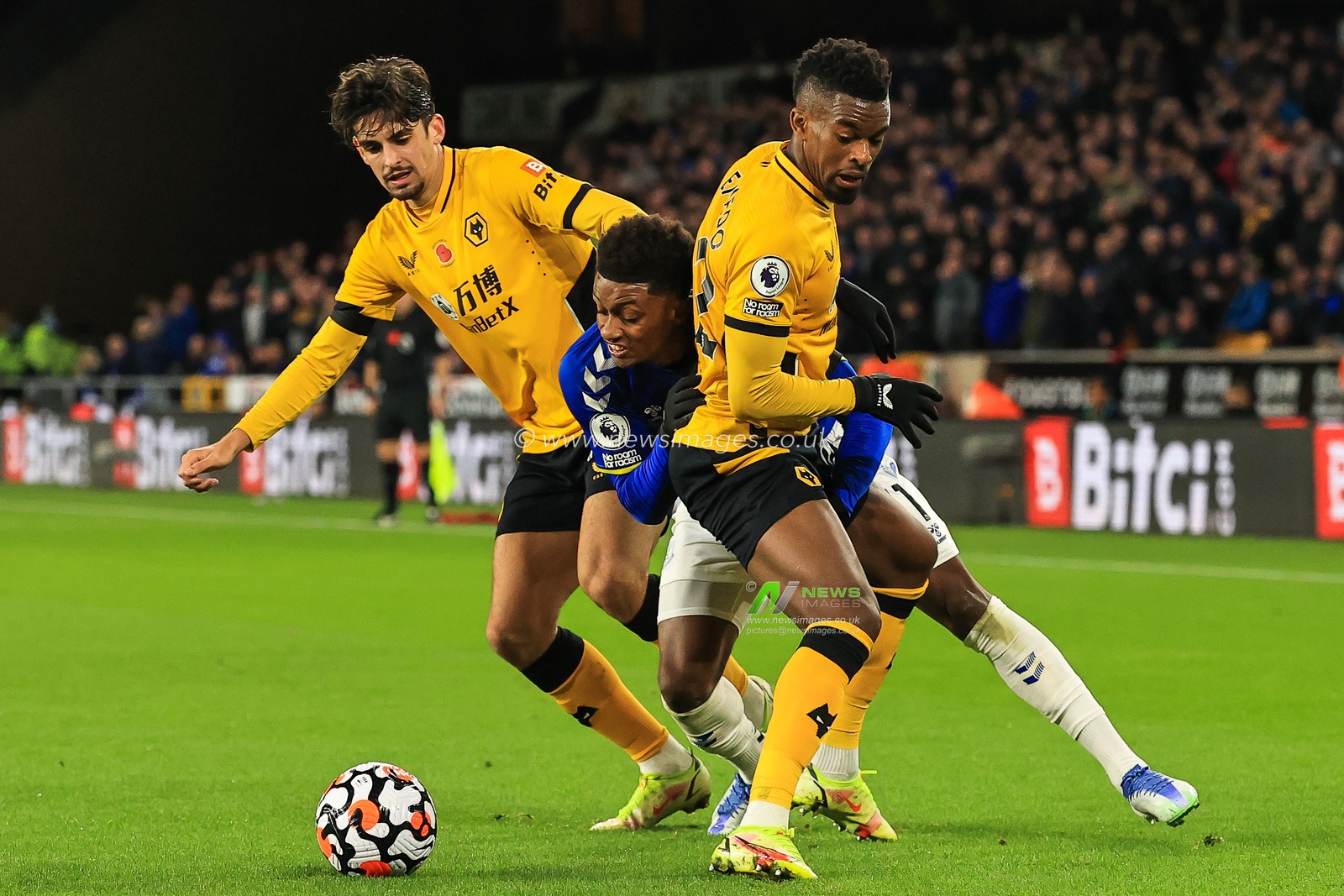 Demarai Gray #11 of Everton is held off the ball by Nelson Semedo #22 of Wolverhampton Wanderers as he tries to break through