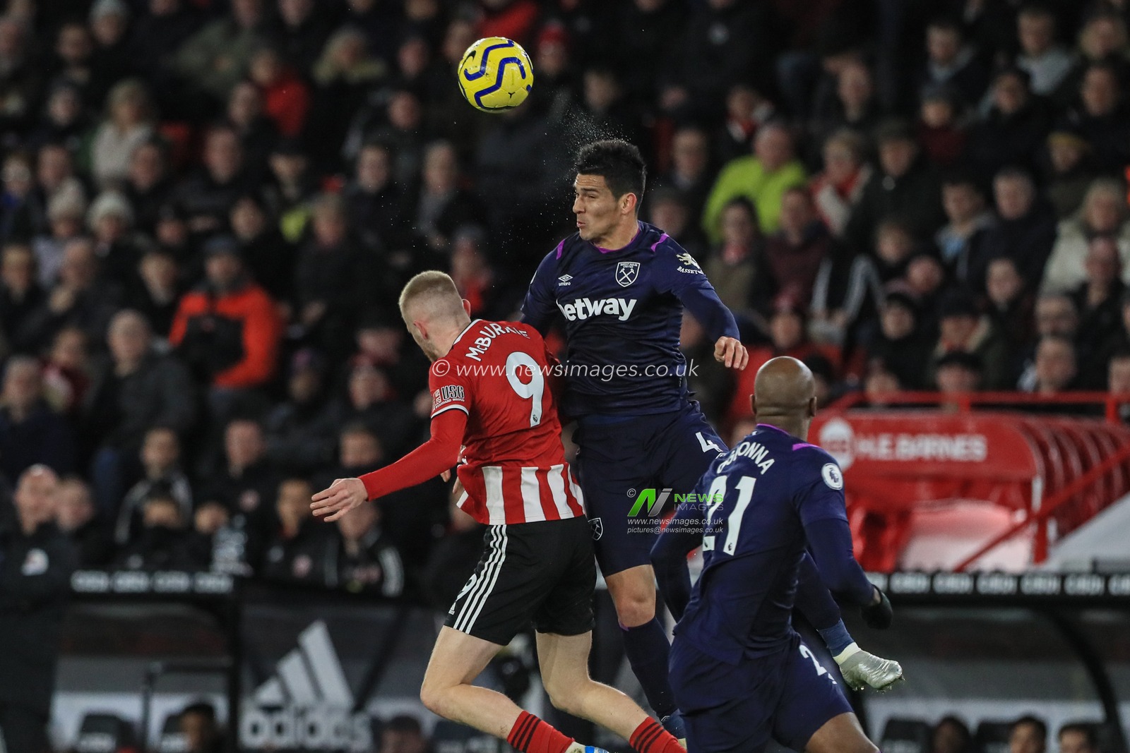 10th January 2020, Bramall Lane, Sheffield, England; Premier League, Sheffield United v West Ham United : Fabian Balbuena (4) of West Ham United wins the ball from Oliver McBurnie (9) of Sheffield United 

Credit: Mark Cosgrove/News Images