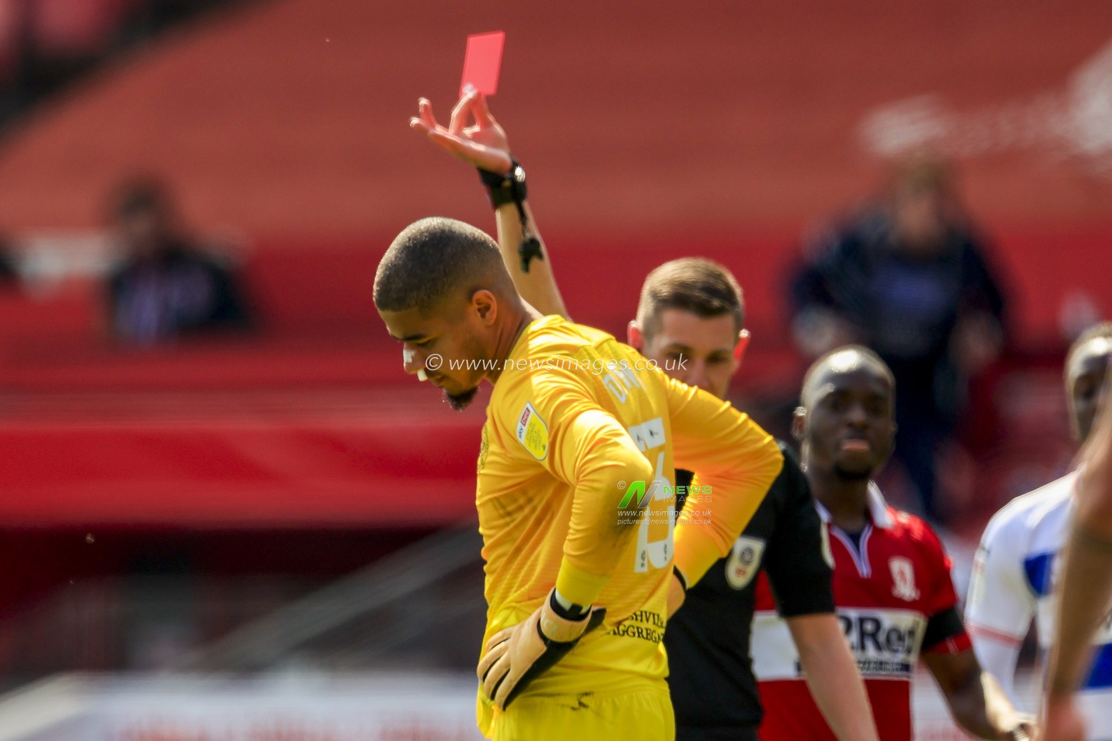 Seny Dieng #13 of Queens Park Rangers receives a straight red card for his foul on Duncan Watmore #18 of Middlesbrough