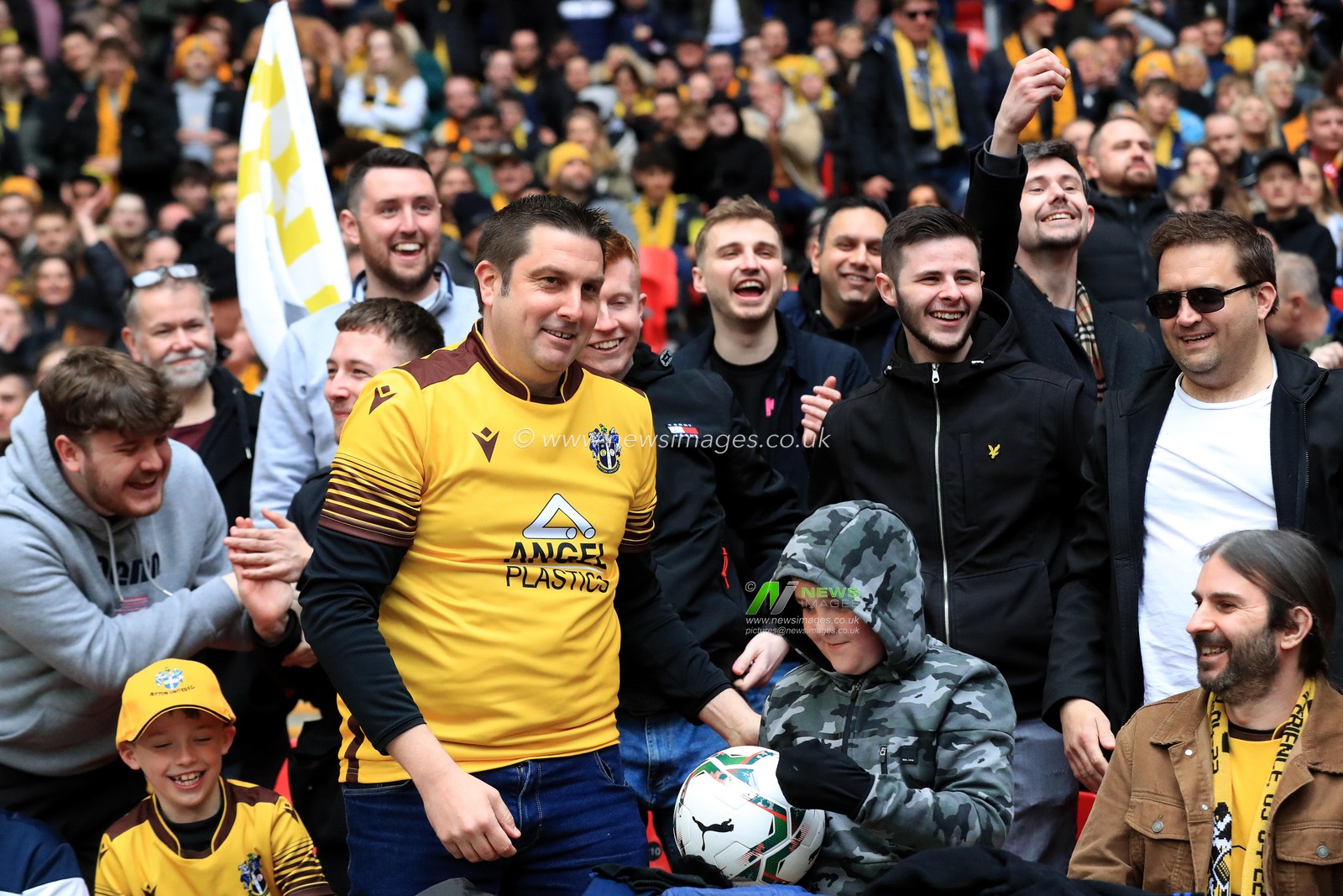 Sutton United fans catch an errant shot on goal.