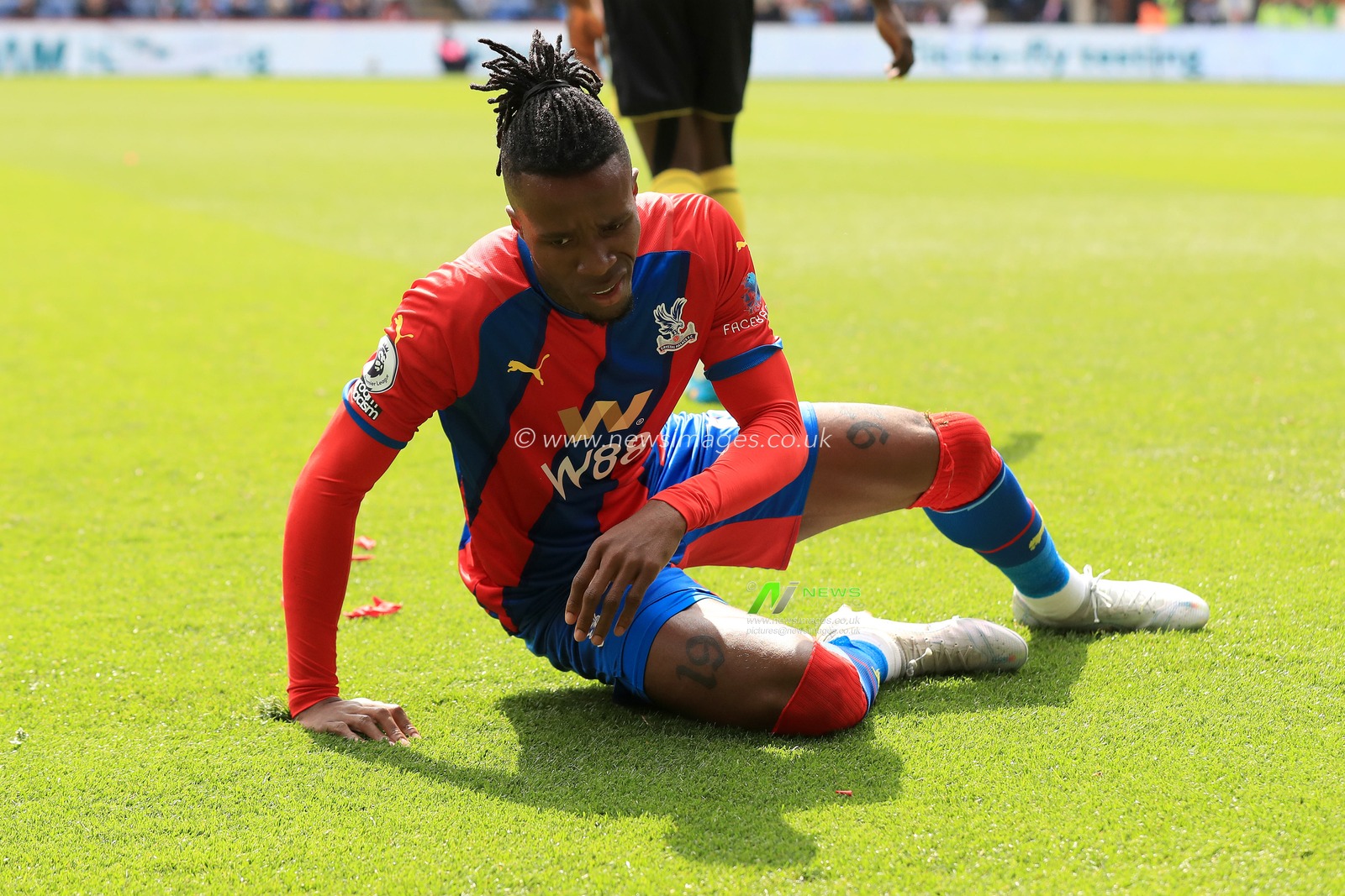 Wilfried Zaha #11 of Crystal Palace is floored by another foul.