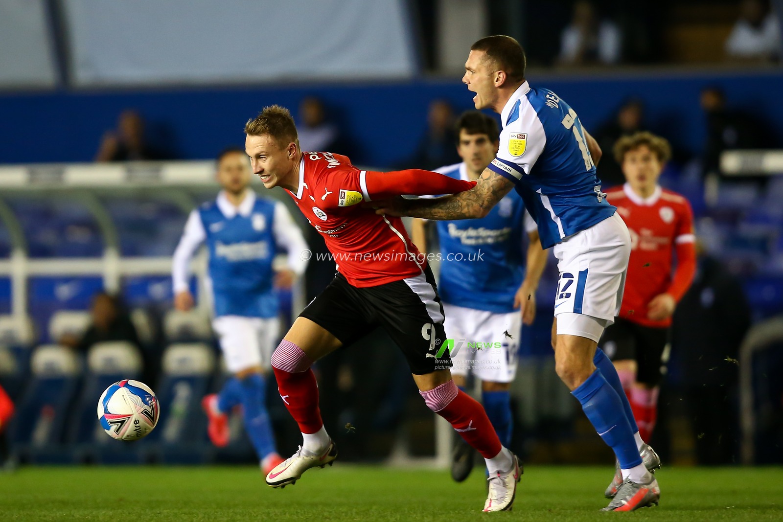 Cauley Woodrow #9 of Barnsley breaks free from Harlee Dean #12 of Birmingham City