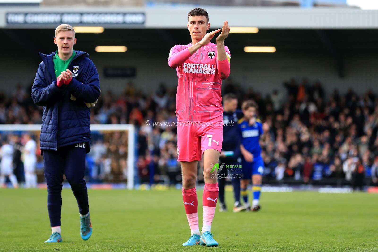 Nik Tzanev #1 of AFC Wimbledon and, Nathan Broome applaud fans at full time.