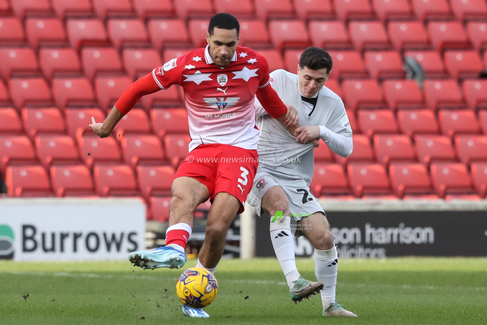 Jon Russell of Barnsley passes the ball pressured by Jack Aitchison of Exeter City during the Sky Bet League 1 match Barnsley vs Exeter City at Oakwell, Barnsley, United Kingdom, 27th January 2024

(Photo by Alfie Cosgrove/News Images)