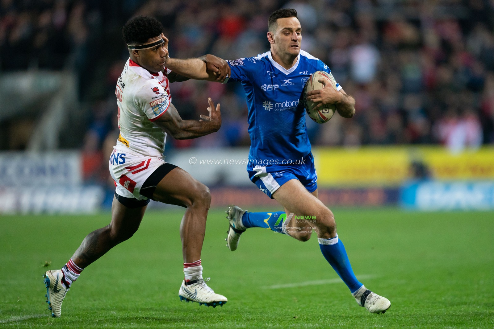 Hull Kingston Rovers Craig Hall pushes off St. Helens's Kevin Naiqama

29th March 2019 , Totally Wicked Stadium, St Helens, England;  Betfred Super League, Round 8, St Helens vs Hull KR 

Credit: Terry Donnelly/News Images