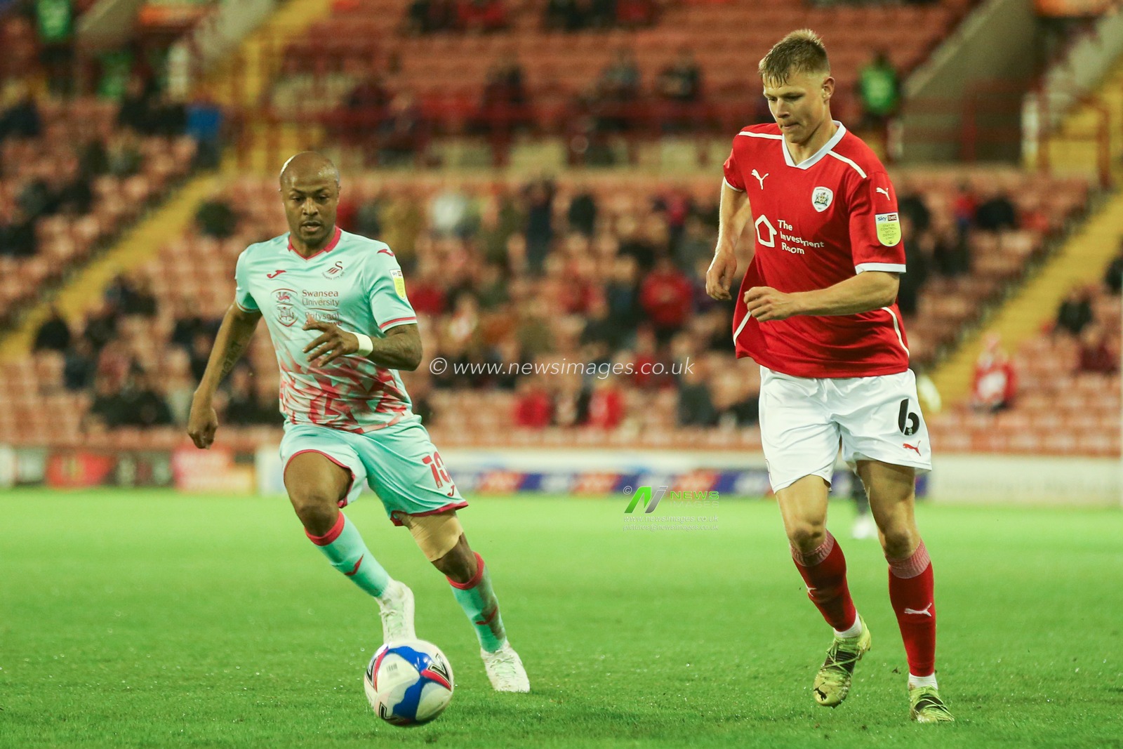 Mads Andersen #6 of Barnsley and Andre Ayew #10 of Swansea City battle for the ball