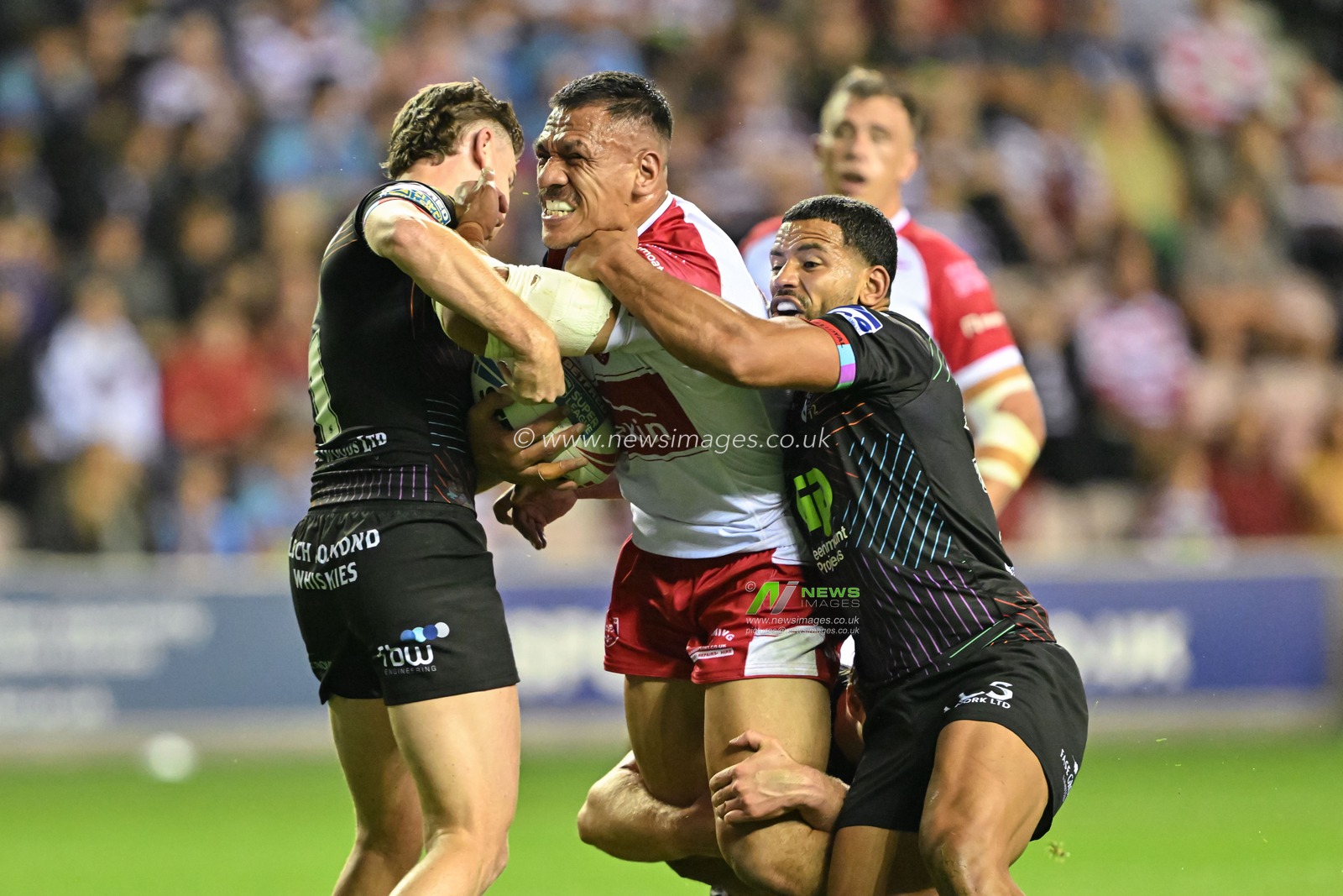 Kelepi Tanginoa of Hull KR is tackled by Bevan French of Wigan Warriors and Jai Field of Wigan Warriors during the Betfred Super League Round 25 match Wigan Warriors vs Hull KR at The Brick Community Stadium, Wigan, United Kingdom, 6th September 2024

(Photo by Cody Froggatt/News Images)