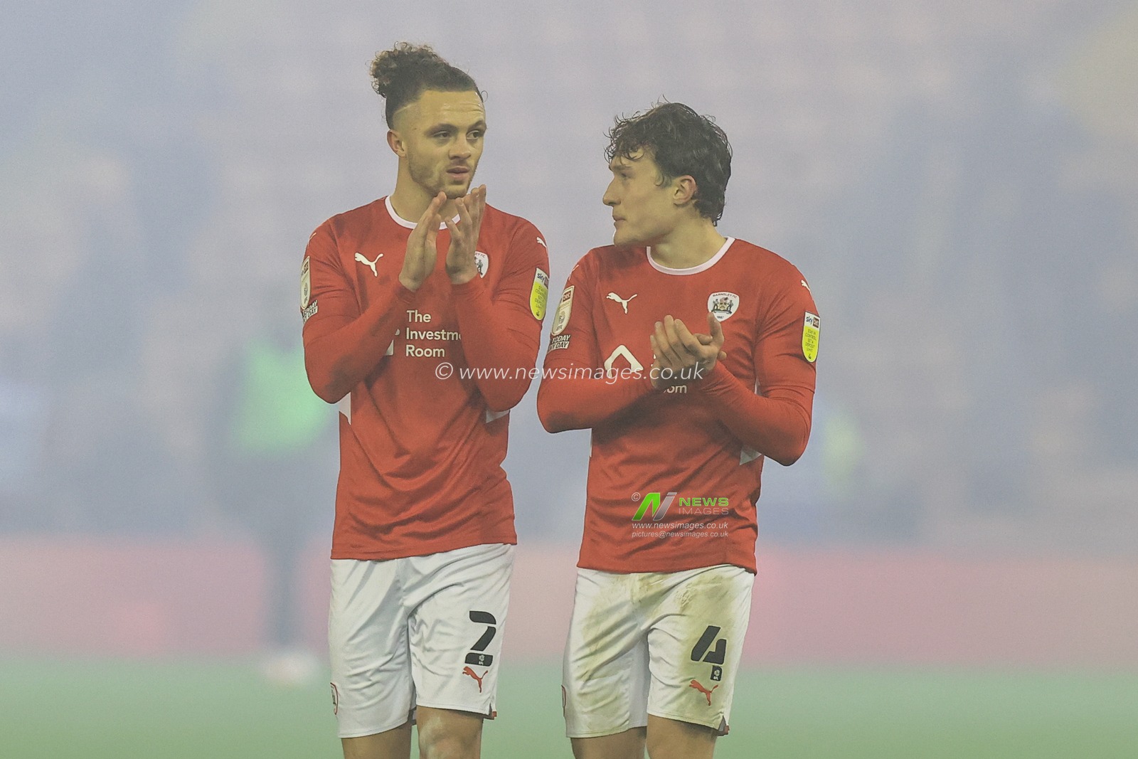 Jordan Williams #2 of Barnsley and Callum Styles #4 of Barnsley applaud the home fans