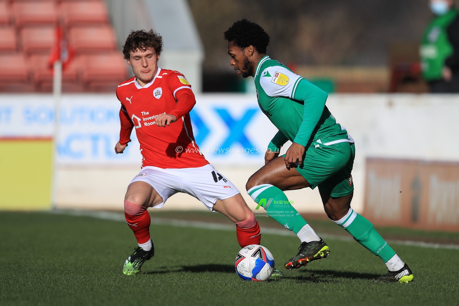 Mahlon Romeo #12 of Millwall breaks as Callum Styles #4 of Barnsley tracks him