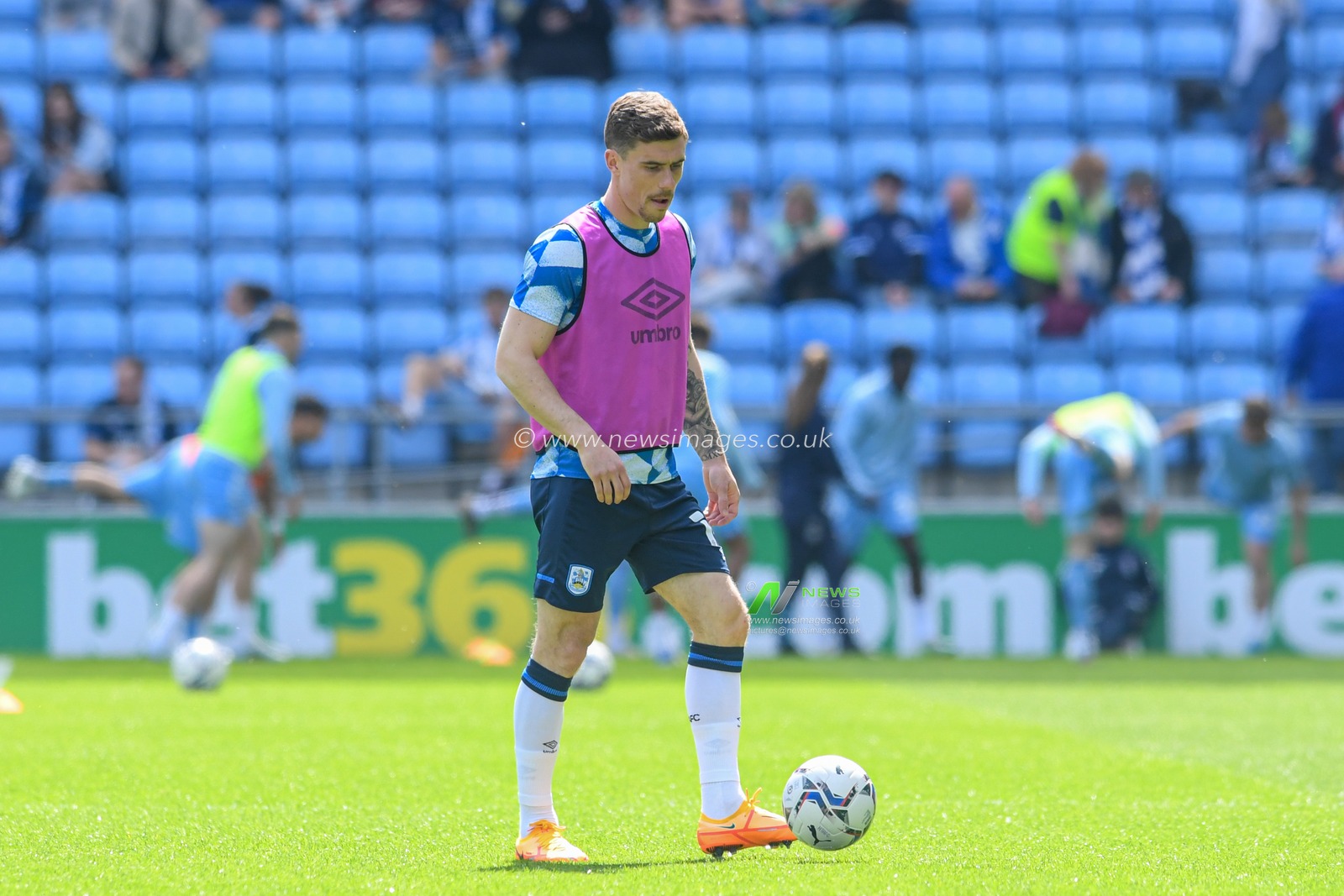 Josh Ruffels #14 of Huddersfield Town warming up before the game