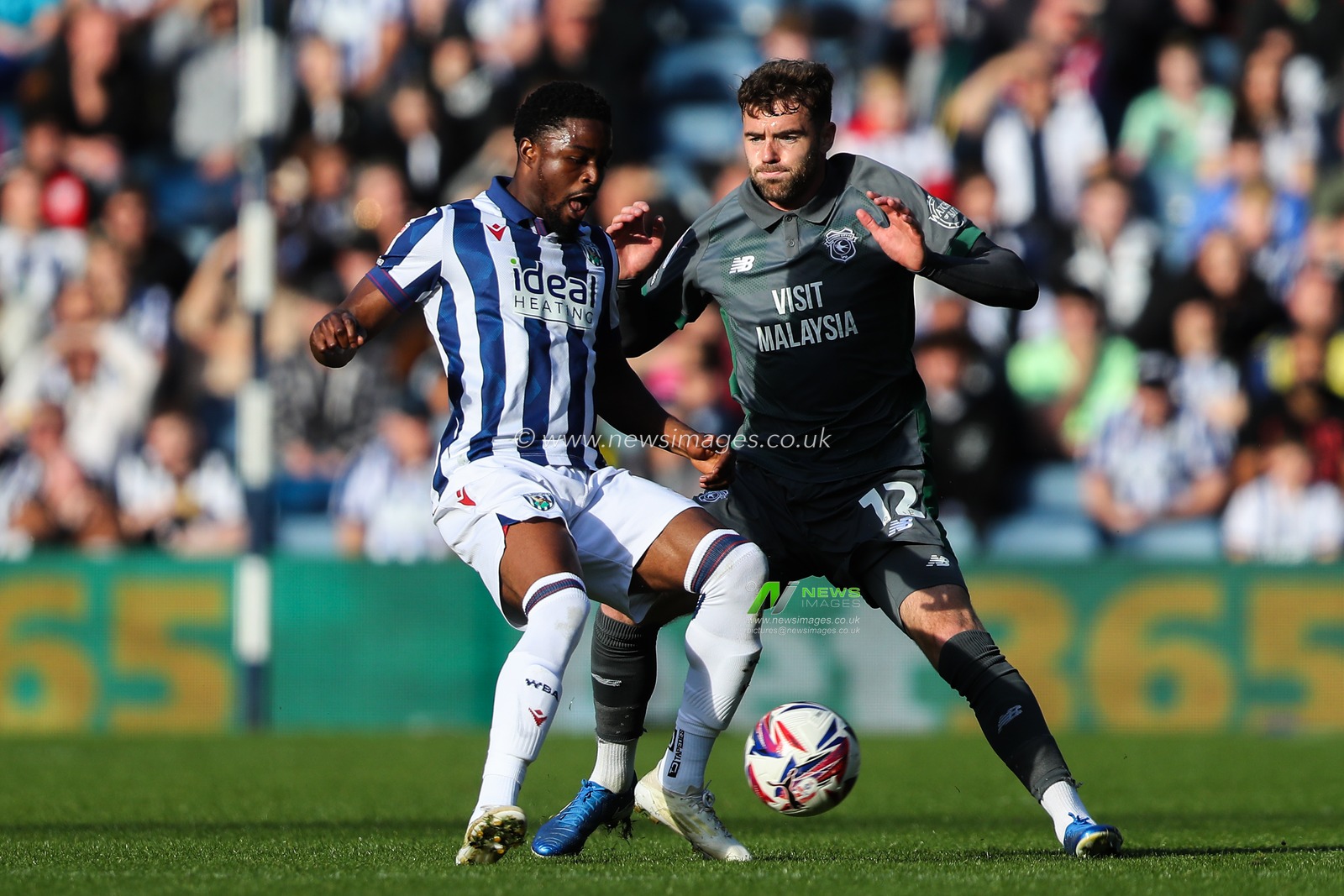Josh Maja of West Bromwich Albion passes the ball whilst getting pressured by Calum Chambers of Cardiff City during the Sky Bet Championship match West Bromwich Albion vs Cardiff City at The Hawthorns, West Bromwich, United Kingdom, 26th October 2024

(Photo by Gareth Evans/News Images)