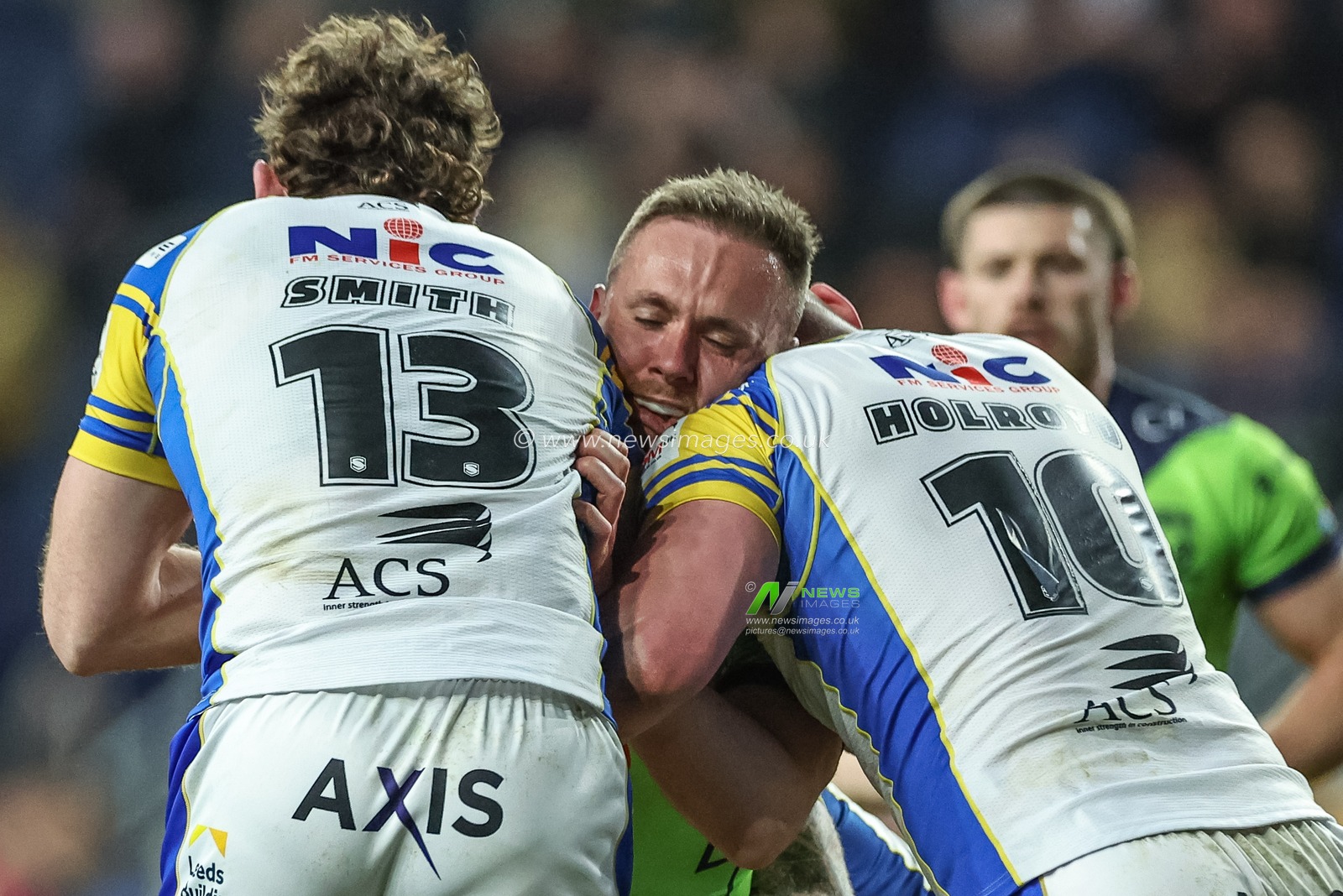Ben Currie of Warrington Wolves is tackled by Cameron Smith of Leeds Rhinos and Tom Holroyd of Leeds Rhinos during the Betfred Super League Round 7 match Leeds Rhinos vs Warrington Wolves at Headingley Stadium, Leeds, United Kingdom, 5th April 2024

(Photo by Mark Cosgrove/News Images)