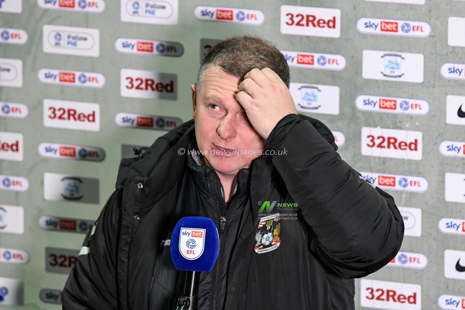 Mark Robins manager of Coventry City scratches his head during his post match interview