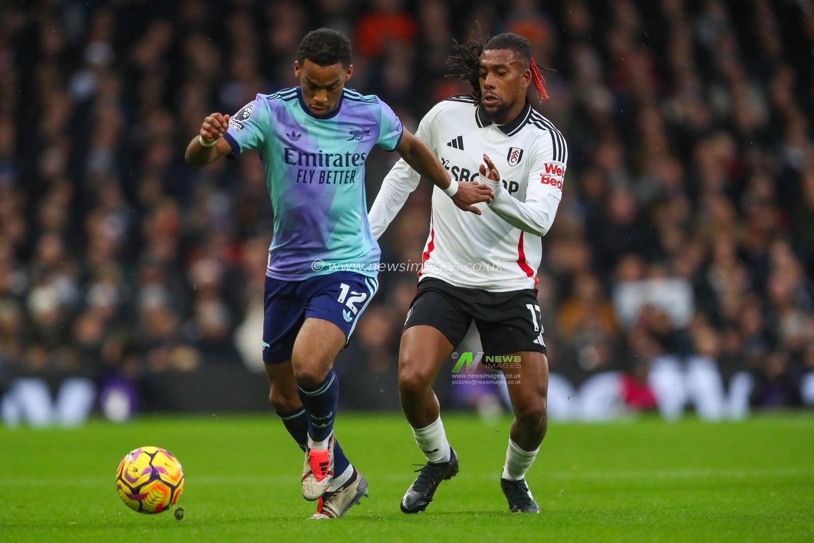 Jurrien Timber of Arsenal holds off Alex Iwobi of Fulham during the Premier League match Fulham vs Arsenal at Craven Cottage, London, United Kingdom, 8th December 2024

(Photo by Gareth Evans/News Images)