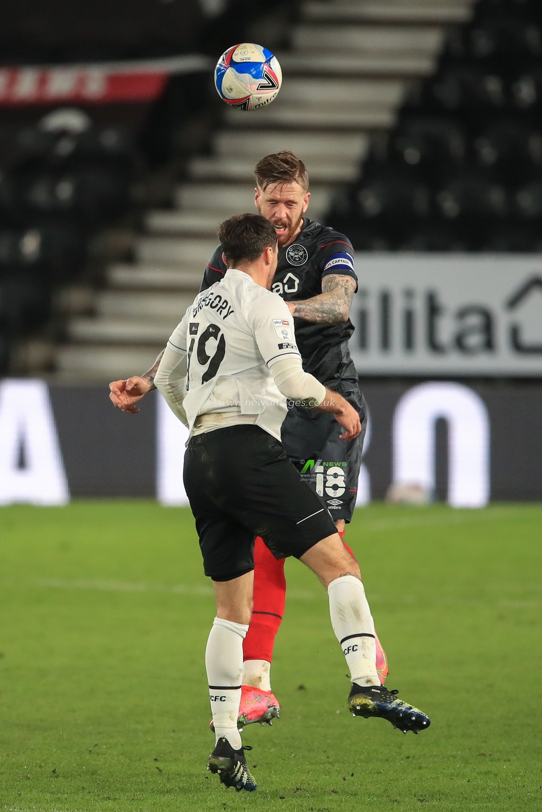 Pontus Jansson #18 of Brentford heads clear as Lee Gregory #19 of Derby County pressures