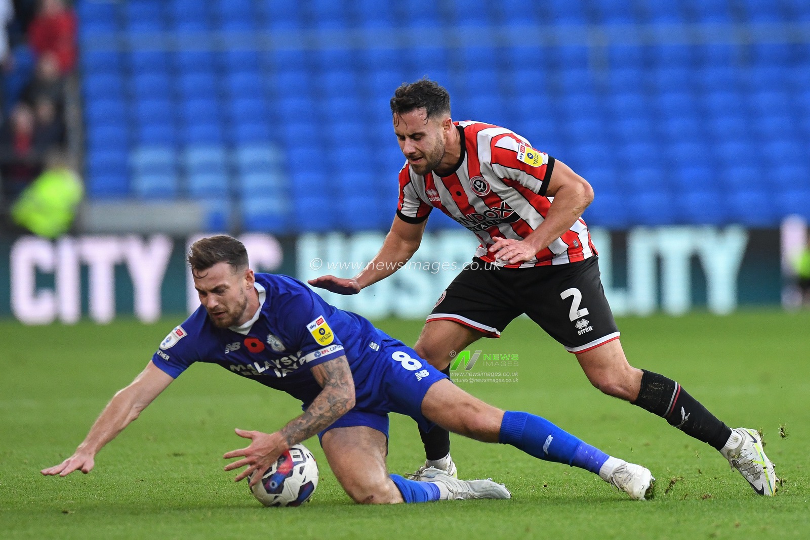 Joe Ralls #8 of Cardiff City  fouled by George Baldock #2 of Sheffield United during the Sky Bet Championship match Cardiff City vs Sheffield United at Cardiff City Stadium, Cardiff, United Kingdom, 12th November 2022

(Photo by Mike Jones/News Images)