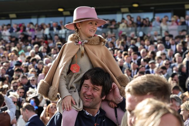 A young race-goer sits on her dads shoulders and watches 6:00 Randox Grand National Handicap Chase the during the 2026 Randox Grand National Day at Aintree Racecourse, Aintree, United Kingdom on 11 April 2026

(Photo by Mark Cosgrove/News Images)