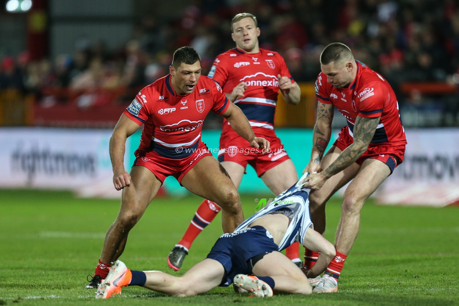 Shaun Kenny-Dowall #4 of Hull KR tackles Jai Field #23 of Wigan Warriors