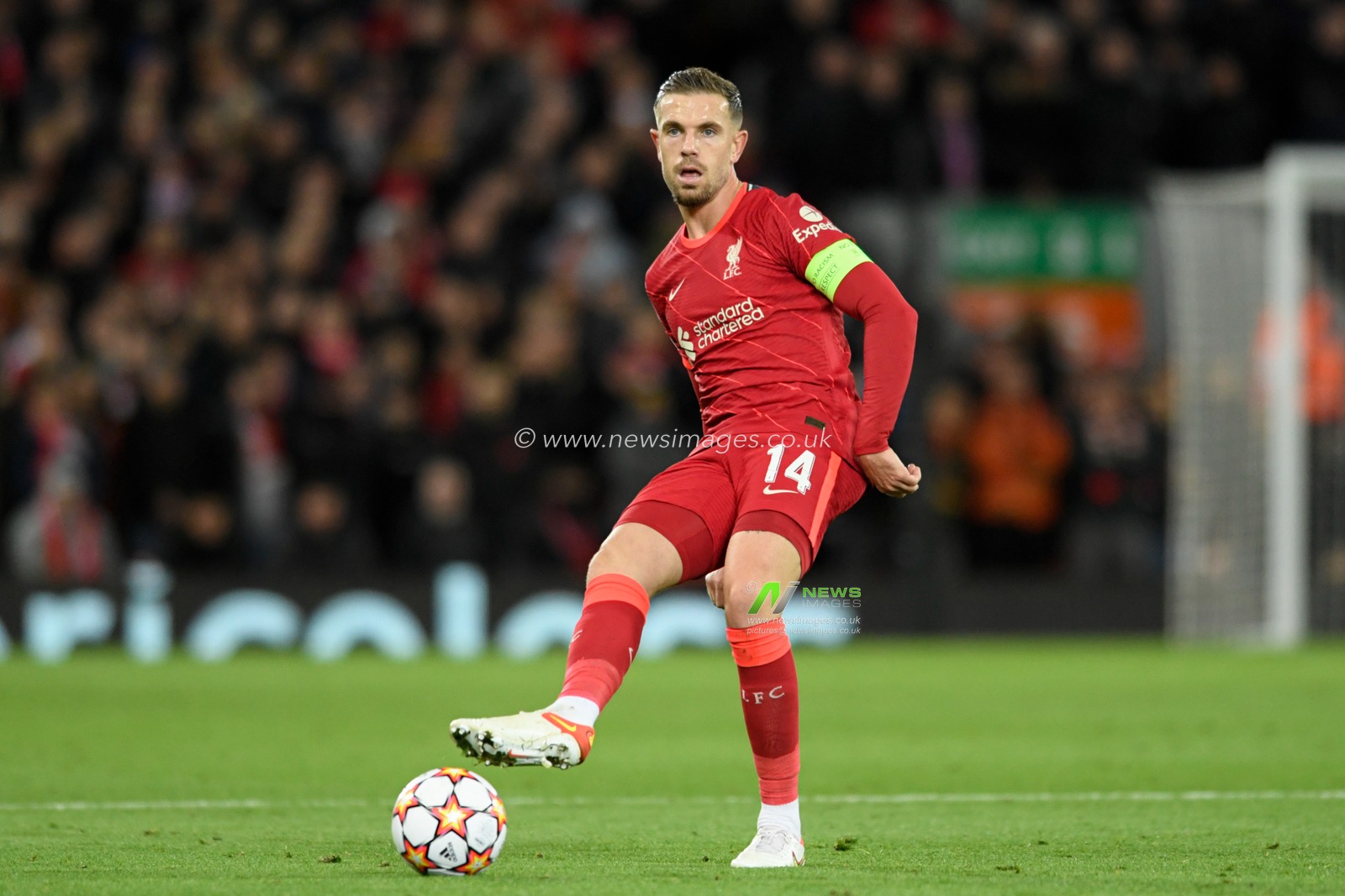 Jordan Henderson #14 of Liverpool passes the ball