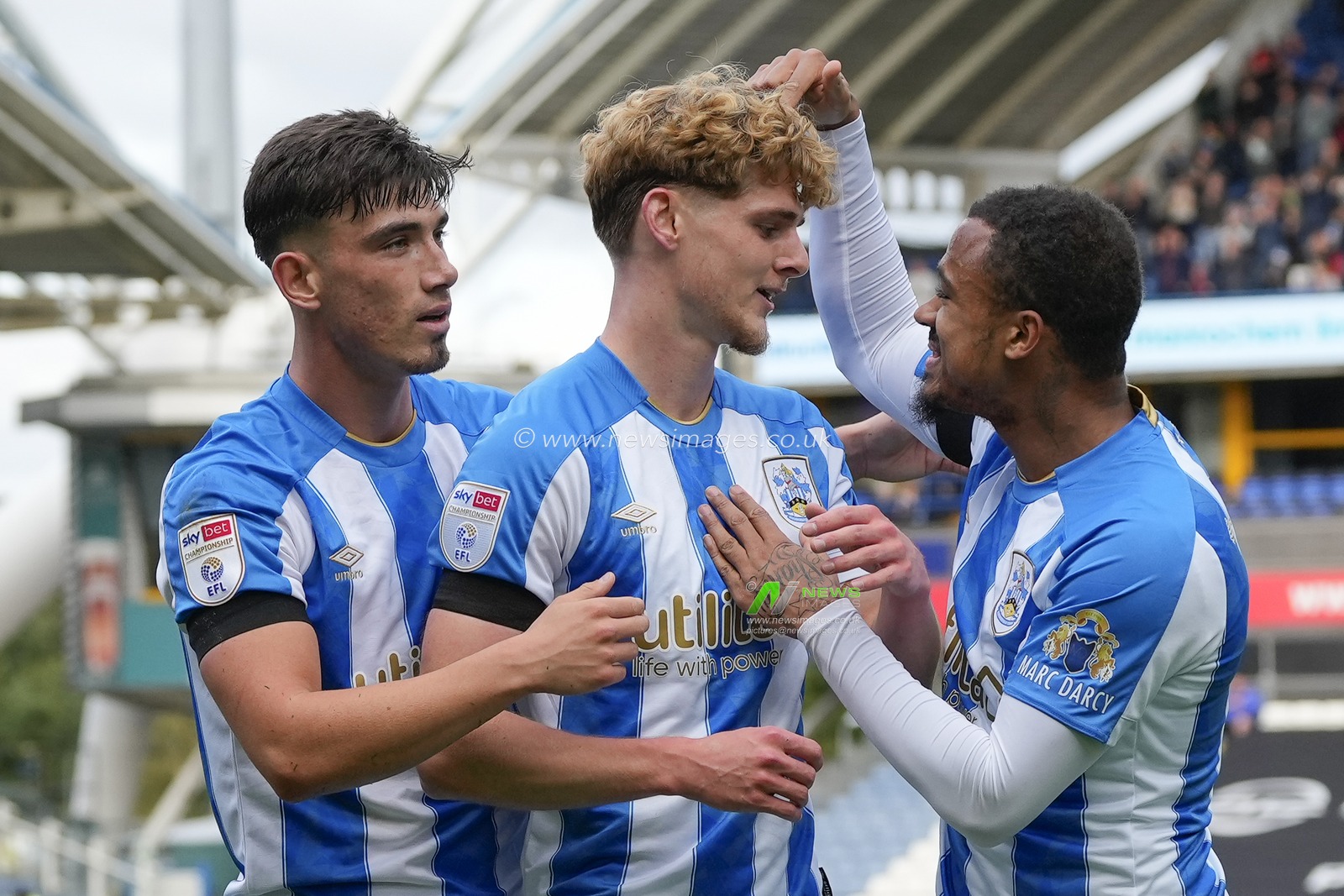 Jack Rudoni #8 of Huddersfield Town celebrates with Josh Koroma #10 of Huddersfield Town and Kian Harratt #22 of Huddersfield Town after scoring to make it 2-0 during the Sky Bet Championship match Huddersfield Town vs Queens Park Rangers at John Smith's Stadium, Huddersfield, United Kingdom, 21st October 2023

(Photo by Steve Flynn/News Images)