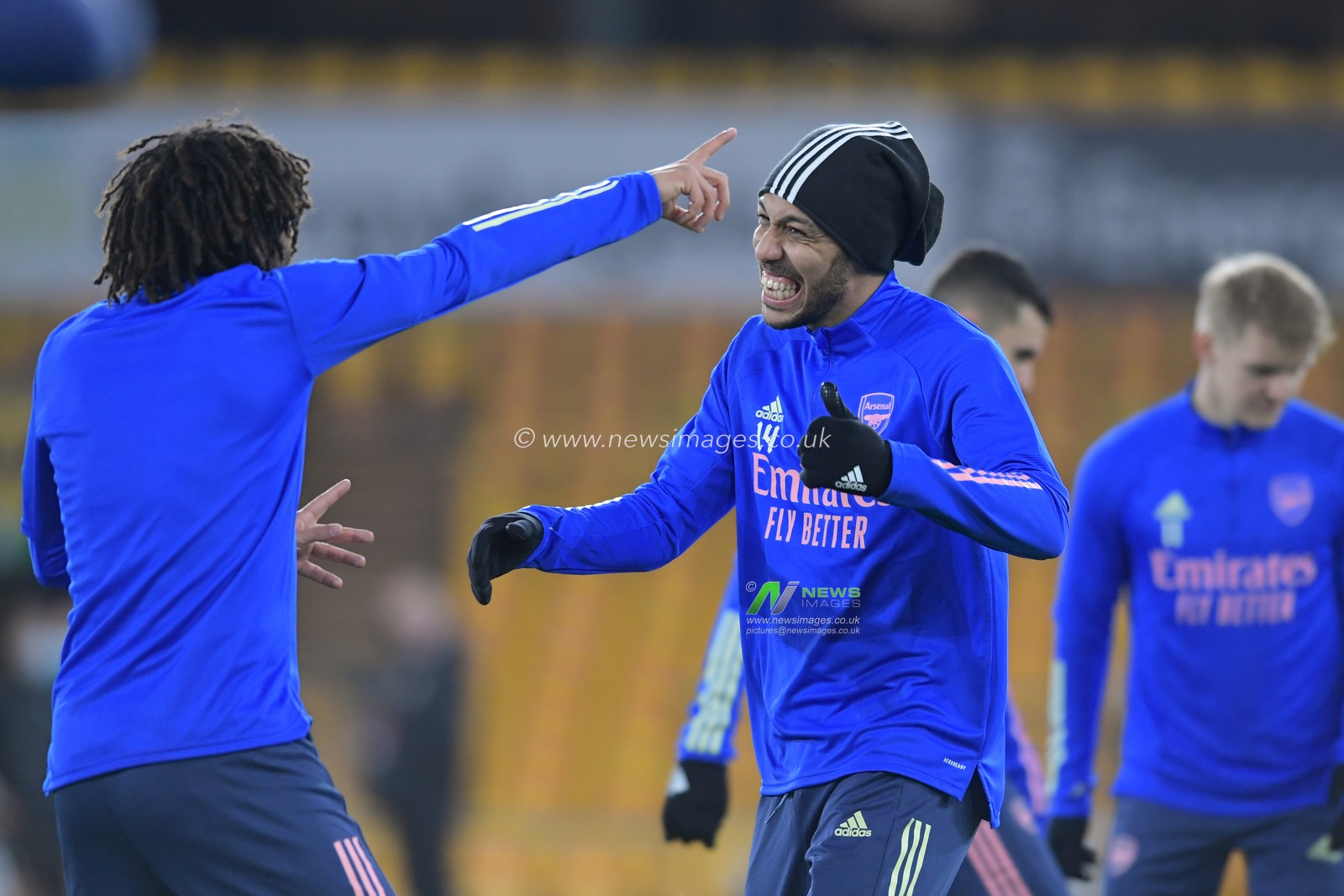 Pierre-Emerick Aubameyang #14 of Arsenal shares a joke with Mohamed Elneny #25 of Arsenal