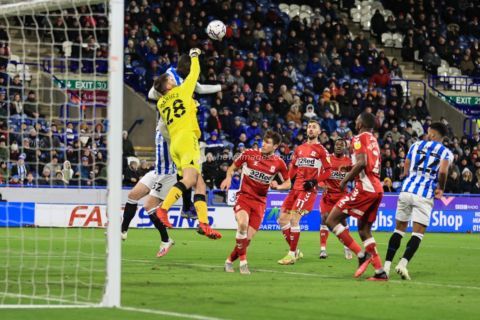 Luke Daniels #28 of Middlesbrough punches clears as Naby Sarr #23 of Huddersfield Town pressures
