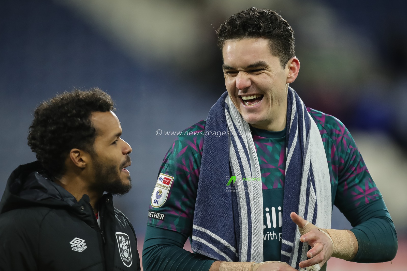 Lee Nicholls #21 of Huddersfield Town shares a joke with team mate Duane Holmes after the Sky Bet Championship match Huddersfield Town vs Rotherham United at John Smith's Stadium, Huddersfield, United Kingdom, 29th December 2022

(Photo by James Heaton/News Images)